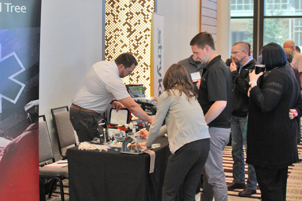 Exhibitors interacting with attendees at Medical Director Conference